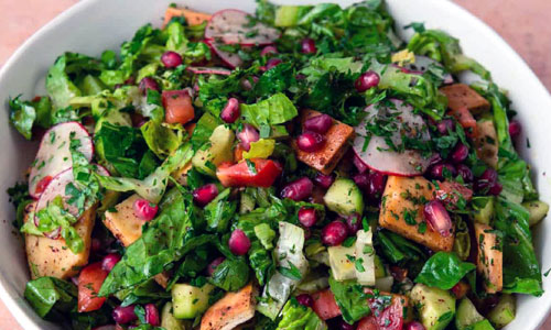 Colorful Mediterranean Fattoush salad topped with crispy flatbread