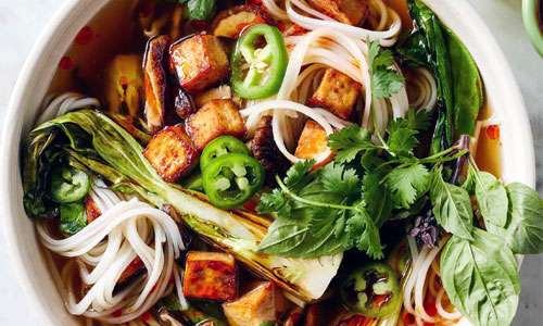 Hot piping bowl of Vietnamese Vegetable Pho with aromatic herbs